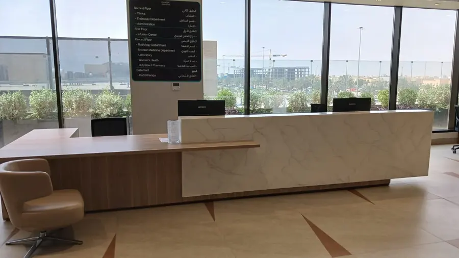 Long reception counter in a lobby with floor-to-ceiling windows